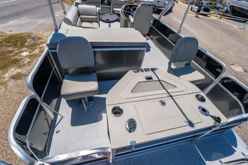 Slide: The Image of 2021 South Bay 224FCR pontoon boat interior with seating and helm, docked on a sunny day. - 18