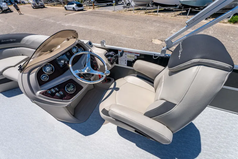 Slide: The Image of Captain's seat and helm of 2021 South Bay 224FCR boat, featuring modern controls and steering. - 21