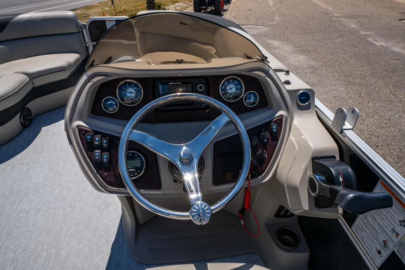 Slide: The Image of 2021 South Bay 224FCR boat dashboard with steering wheel and control panel. - 22