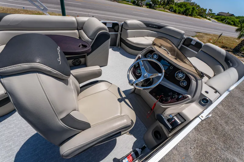 Slide: The Image of Interior of 2021 South Bay 224FCR pontoon boat with plush seating and modern dashboard. - 23