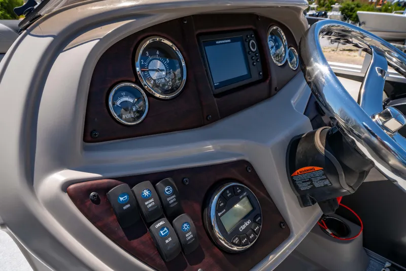 Slide: The Image of Dashboard of 2021 South Bay 224FCR boat with gauges and controls. - 24