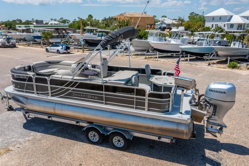 Slide: The Image of 2021 South Bay 224FCR pontoon boat with Honda outboard motor on a trailer. - 6