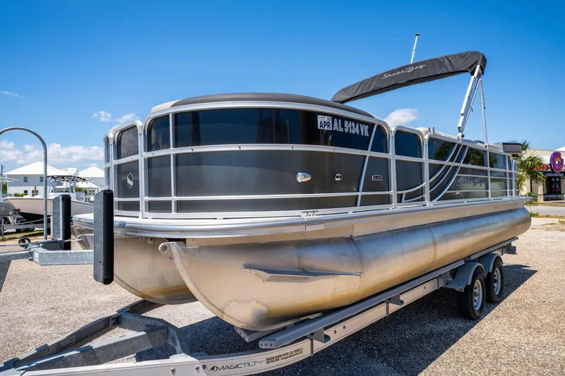 Slide: The Image of 2021 South Bay 224FCR pontoon boat on trailer under clear blue sky. - 7