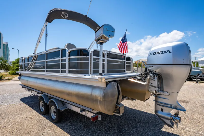 Slide: The Image of 2021 South Bay 224FCR pontoon boat with Honda outboard motor on a trailer. - 8