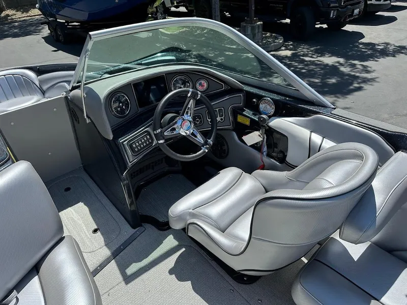 Slide: The Image of 2025 Sanger V215 SX boat interior with sleek gray seating and modern dashboard. - 11