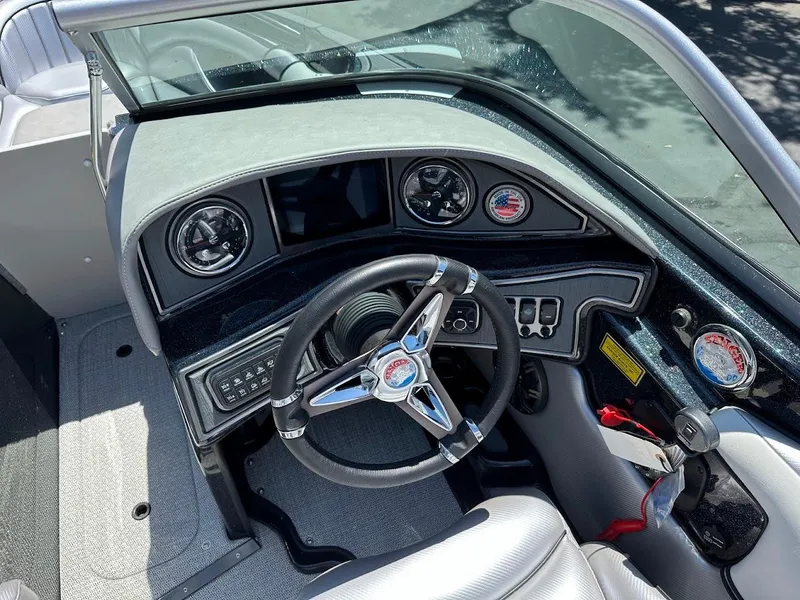 Slide: The Image of 2025 Sanger V215 SX boat dashboard with steering wheel and gauges. - 13
