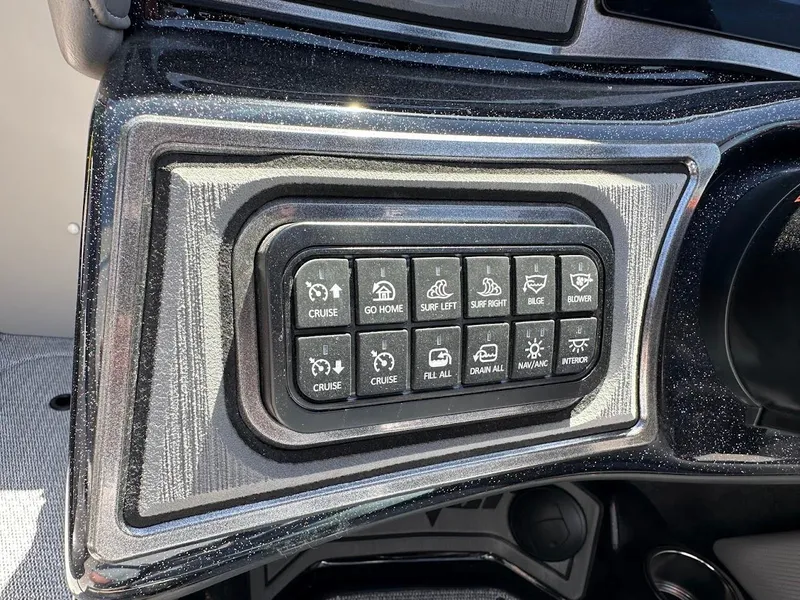 Slide: The Image of Control panel of a 2025 Sanger V215 SX boat with various function buttons. - 15