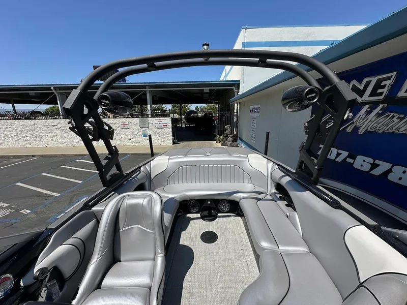 Slide: The Image of 2025 Sanger V215 SX boat interior with gray seating and wakeboard tower. - 23