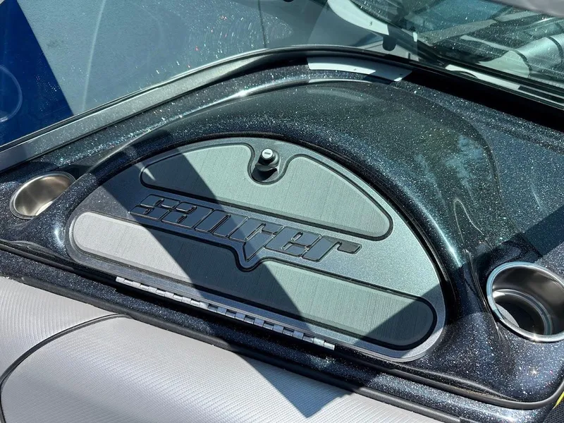 Slide: The Image of 2025 Sanger V215 SX dashboard with logo and cup holders. - 25