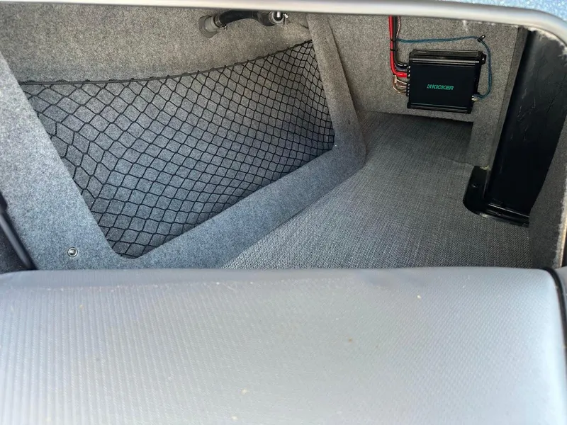 Slide: The Image of 2025 Sanger V215 SX interior storage compartment with netting and electronic components. - 27