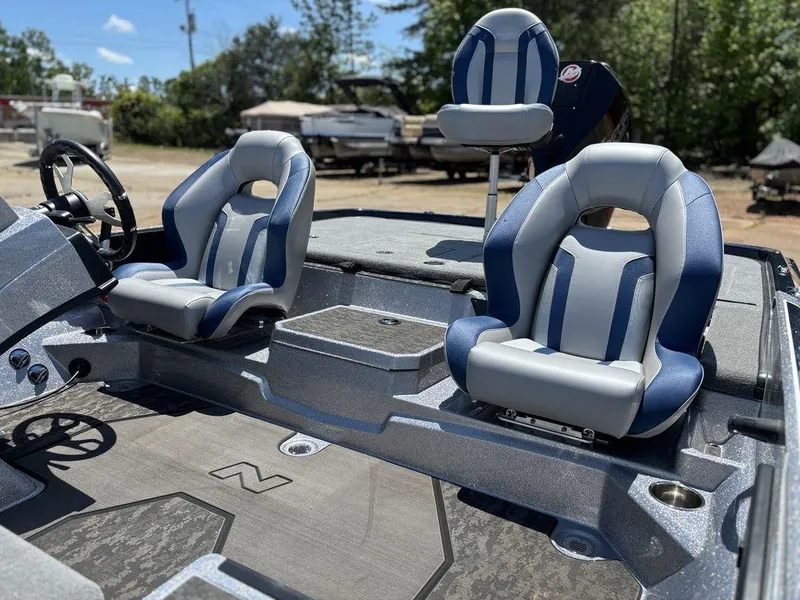 Slide: The Image of 2025 Nitro Z21 XL boat interior with blue and gray seating, steering wheel, and console. - 10