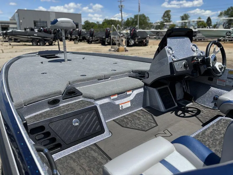 Slide: The Image of 2025 Nitro Z21 XL boat interior with steering console and seating, displayed outdoors. - 11