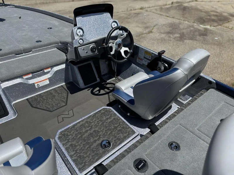 Slide: The Image of 2025 Nitro Z21 XL boat cockpit with steering wheel and seating. - 12