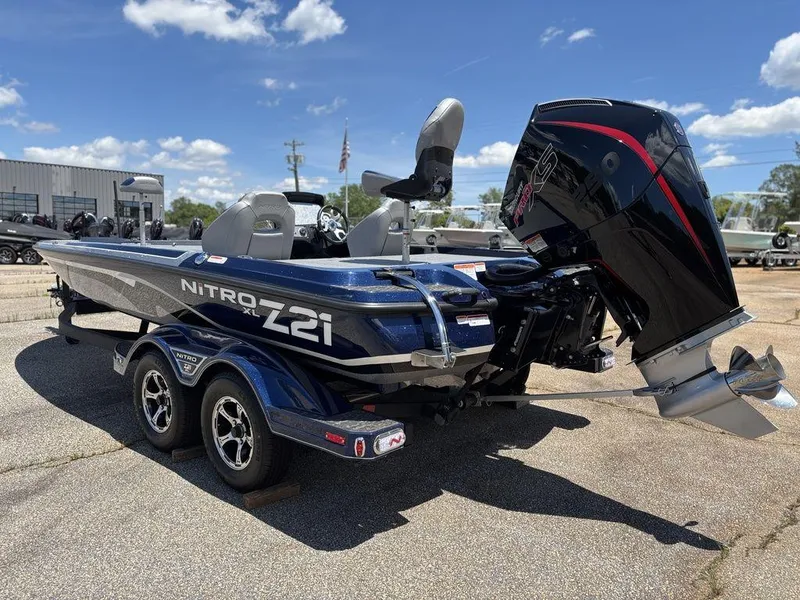 Slide: The Image of 2025 Nitro Z21 XL boat with powerful outboard motor, parked on a sunny day. - 3