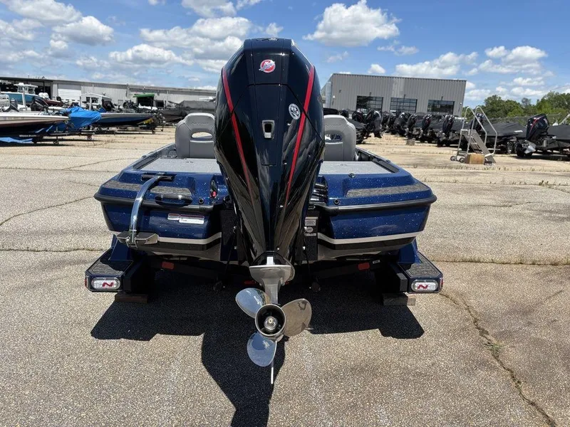 Slide: The Image of 2025 Nitro Z21 XL boat, rear view with powerful outboard motor, parked outdoors. - 4
