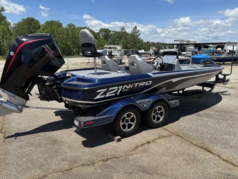 Slide: The Image of 2025 Nitro Z21 XL boat on trailer, parked outdoors under a clear sky. - 5