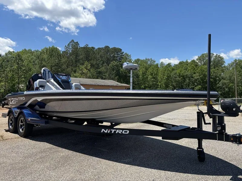 Slide: The Image of 2025 Nitro Z21 XL boat on trailer, parked outdoors under clear sky. - 7