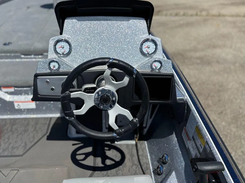 Slide: The Image of 2025 Nitro Z21 XL boat dashboard with steering wheel and gauges. - 9