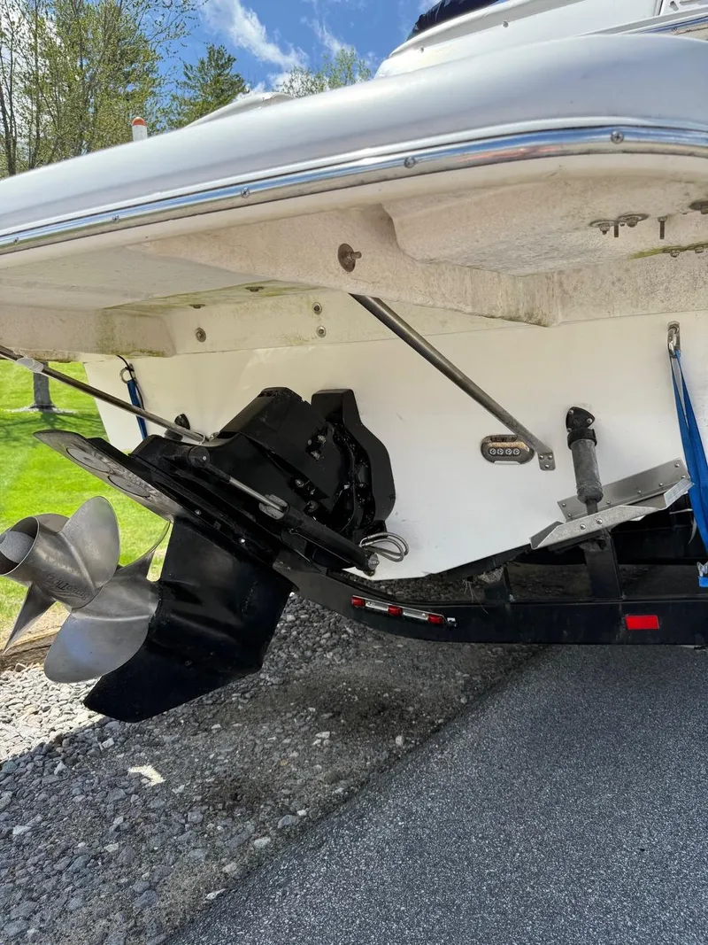 Slide: The Image of 2008 Regal 2750 boat stern with propeller and trailer, parked on gravel. - 18