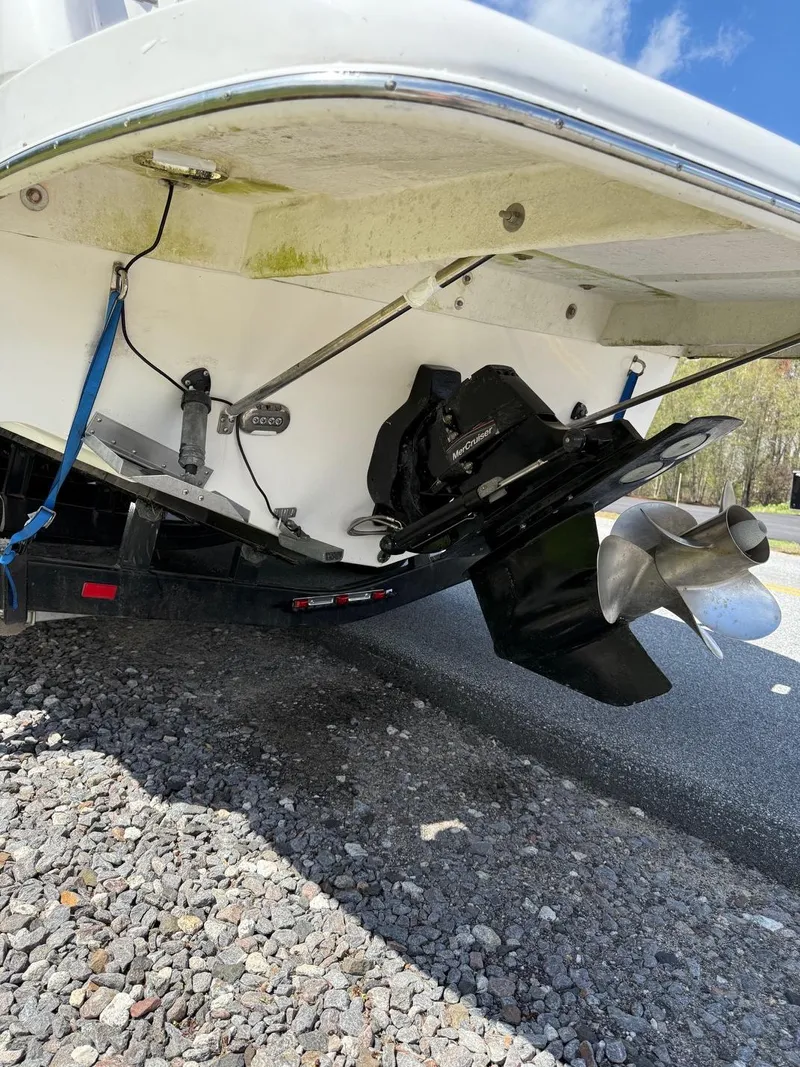 Slide: The Image of 2008 Regal 2750 boat stern with dual propellers on a trailer. - 21