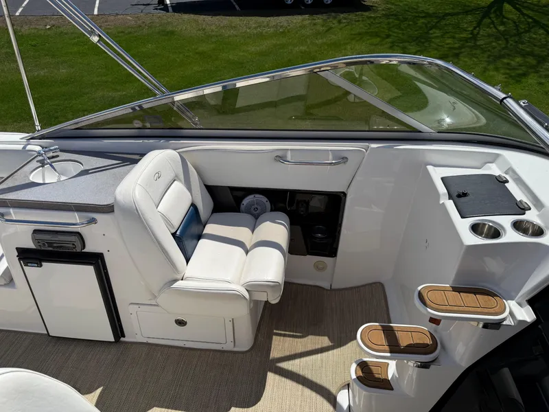 Slide: The Image of Interior of a 2008 Regal 2750 boat featuring seating and control area. - 23