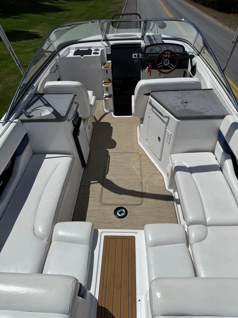 Slide: The Image of 2008 Regal 2750 boat interior with white seating and steering console. - 25