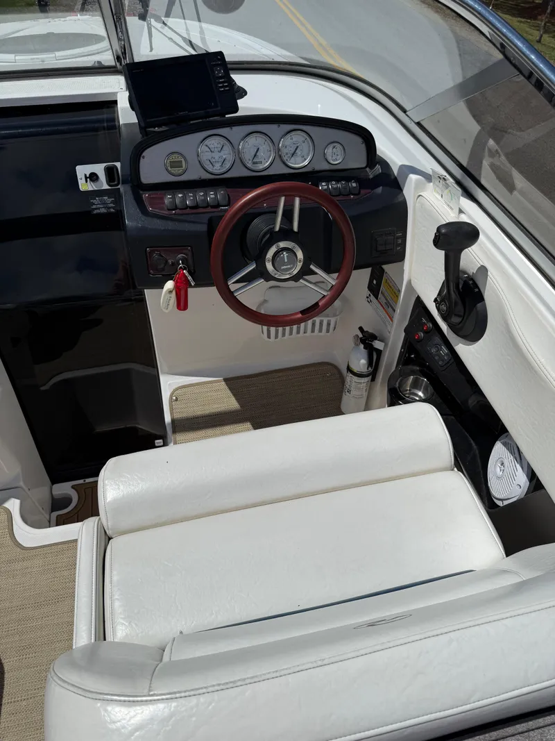 Slide: The Image of 2008 Regal 2750 boat cockpit with steering wheel and instrument panel. - 26