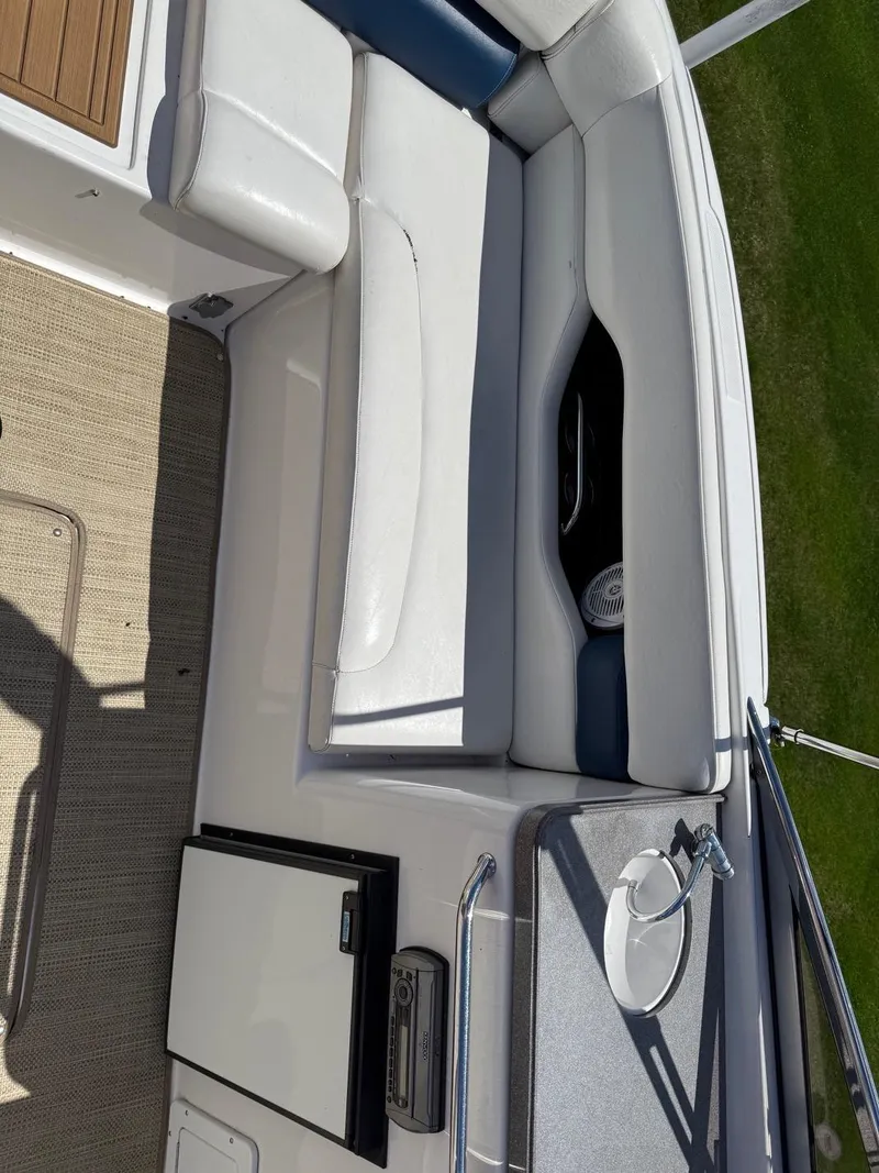 Slide: The Image of 2008 Regal 2750 boat interior with white seating and compact kitchenette. - 28