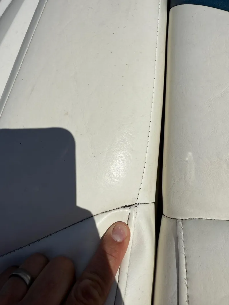 Slide: The Image of Close-up of a 2008 Regal 2750 boat seat with visible seam and minor wear. - 8