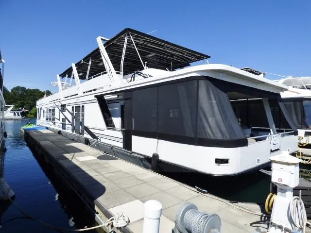 Slide: The Image of 2001 Sumerset 20x103 houseboat docked, featuring sleek design and spacious upper deck. - 0