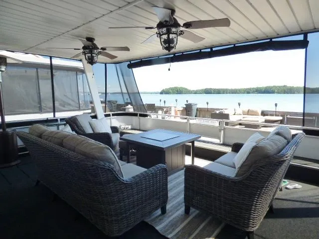 Slide: The Image of Luxurious 2001 Sumerset 20x103 houseboat with spacious deck, wicker seating, and scenic lake view. - 1
