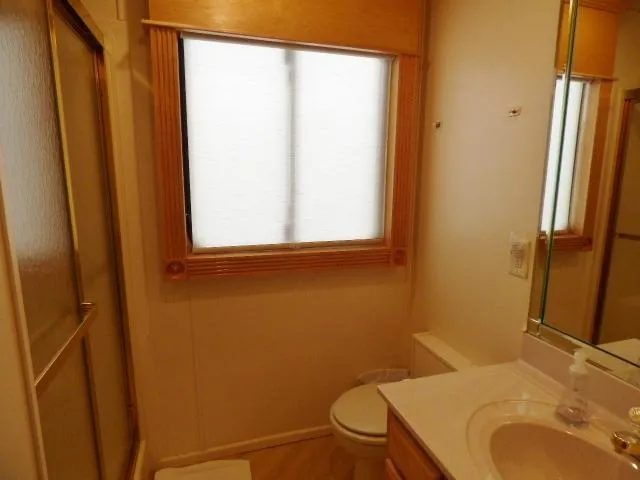 Slide: The Image of Bathroom interior of 2001 Sumerset 20x103 houseboat with shower, sink, and window. - 10