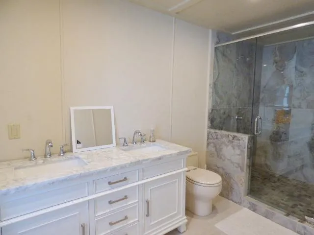 Slide: The Image of Luxurious bathroom with marble vanity and glass shower in 2001 Sumerset 20x103 houseboat. - 13