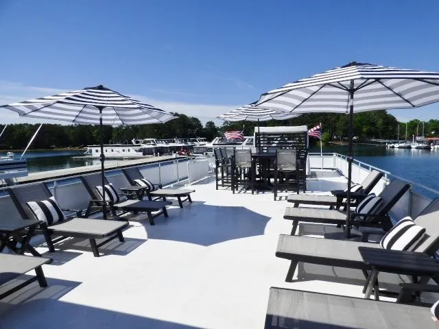 Slide: The Image of Spacious deck of 2001 Sumerset 20x103 houseboat with lounge chairs and umbrellas. - 16