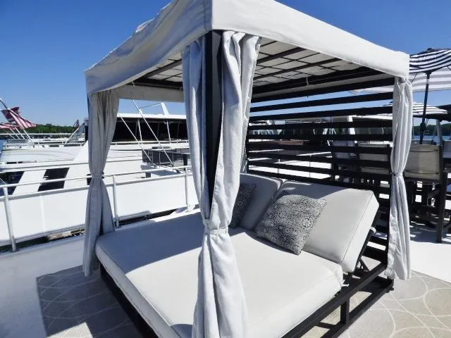Slide: The Image of Luxurious outdoor daybed on 2001 Sumerset 20x103 houseboat, featuring elegant cushions and canopy. - 18