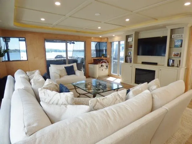 Slide: The Image of Luxurious 2001 Sumerset 20x103 houseboat interior with plush seating and modern entertainment center. - 3