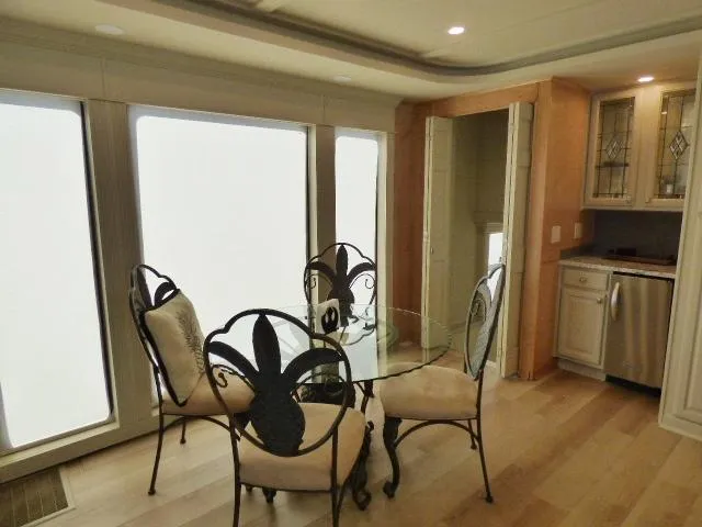 Slide: The Image of Dining area in 2001 Sumerset 20x103 houseboat with elegant chairs and glass table. - 5