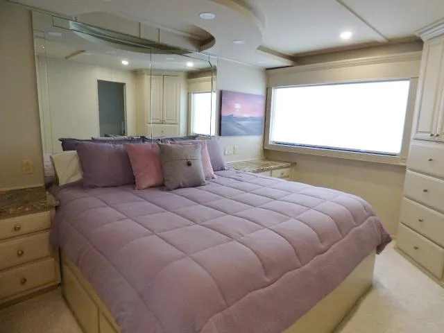 Slide: The Image of Luxurious bedroom in 2001 Sumerset 20x103 houseboat with plush bedding and ample natural light. - 6
