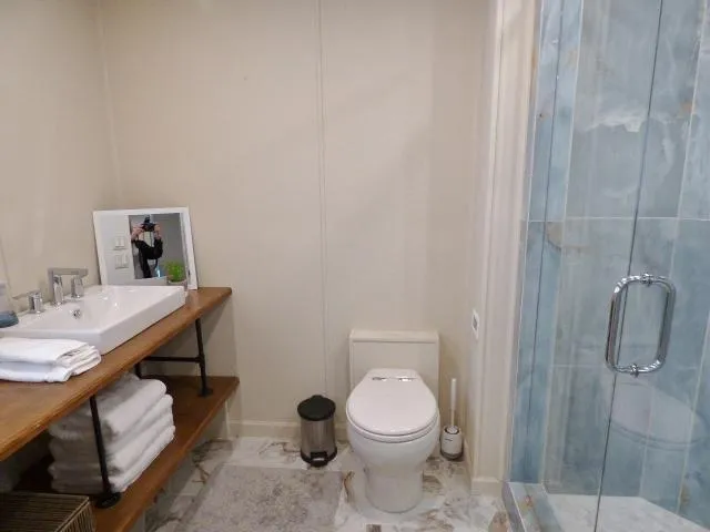 Slide: The Image of Modern bathroom in 2001 Sumerset 20x103 houseboat with sink, toilet, and glass shower. - 7