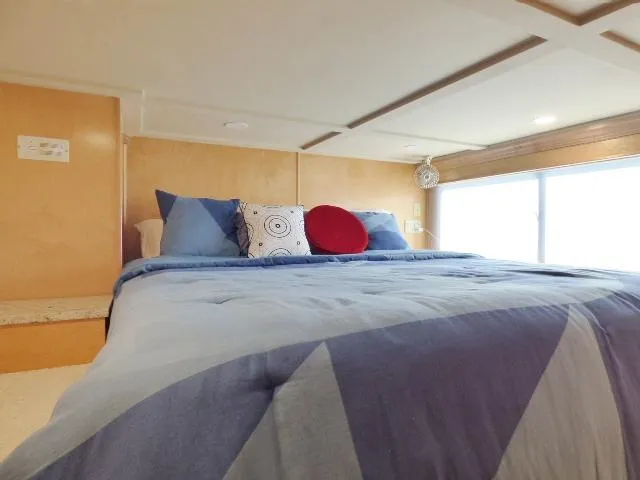 Slide: The Image of Cozy bedroom interior in 2001 Sumerset 20x103 houseboat with blue bedding and decorative pillows. - 8