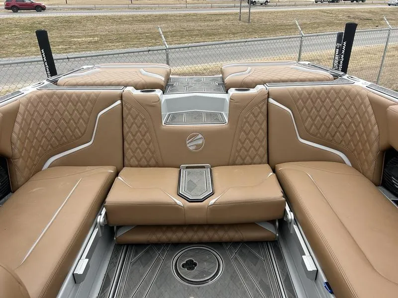 Slide: The Image of 2024 Tigé 22RZX boat interior with tan leather seating and diamond stitching. - 2