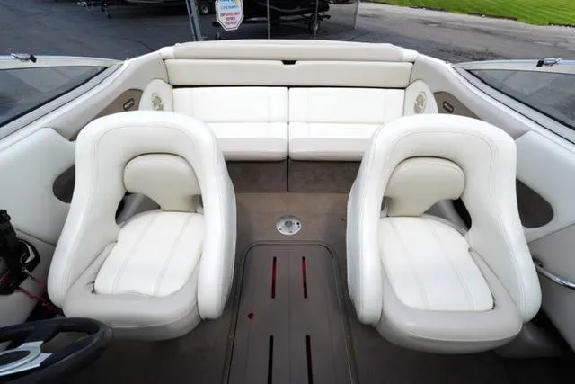 Slide: The Image of Interior of a 2004 Bryant 200 boat with white seating and modern design. - 14