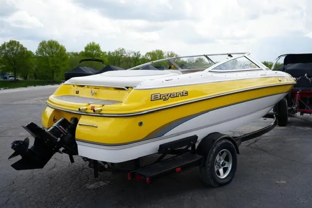 Slide: The Image of Yellow 2004 Bryant 200 boat on trailer, parked outdoors. - 4