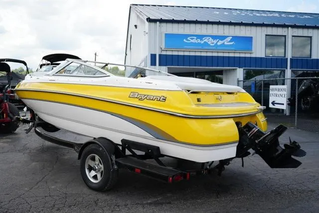 Slide: The Image of Yellow 2004 Bryant 200 boat on trailer outside Sea Ray dealership. - 6