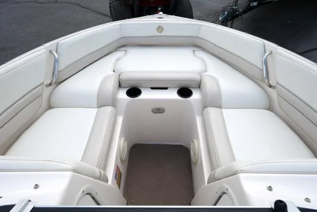 Slide: The Image of Interior of a 2004 Bryant 200 boat with white seating and cup holders. - 8