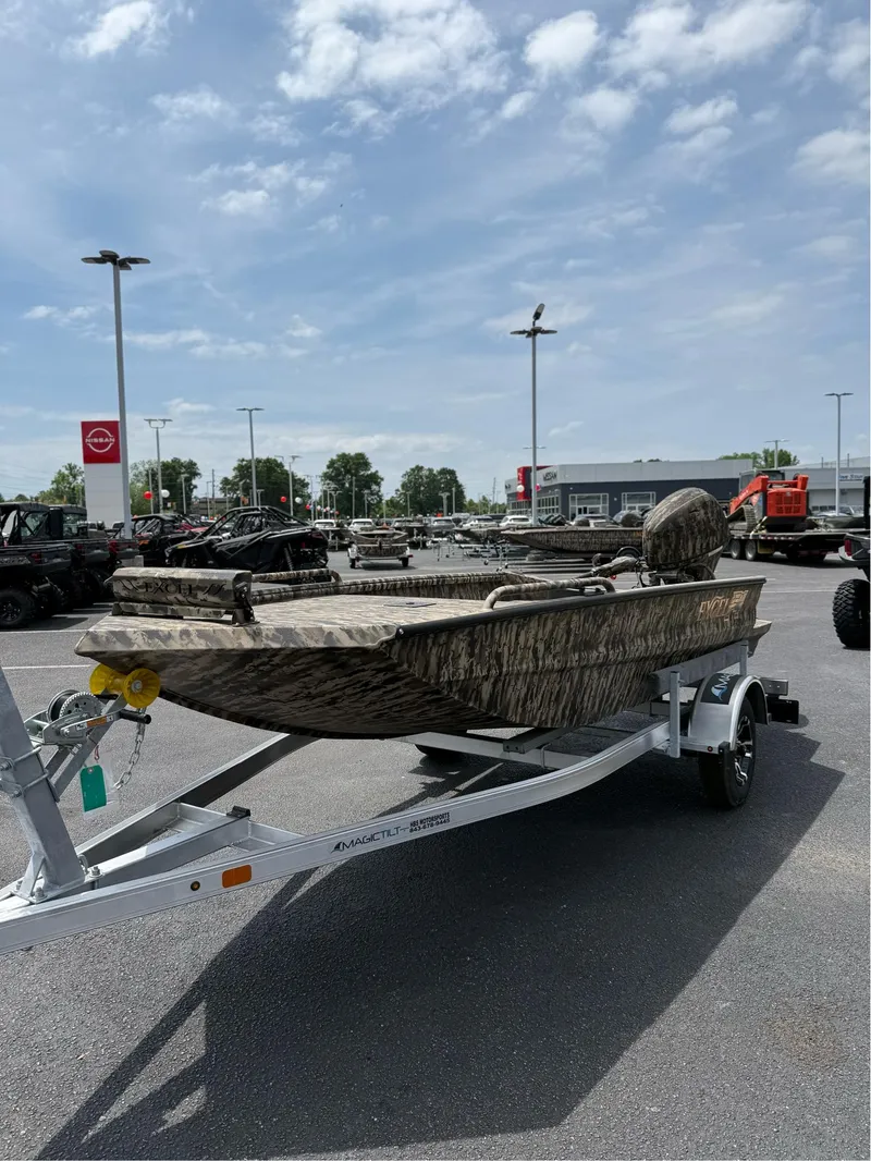 Slide: The Image of 2025 Excel 1651 Viper F4 boat on trailer in dealership lot under cloudy sky. - 11