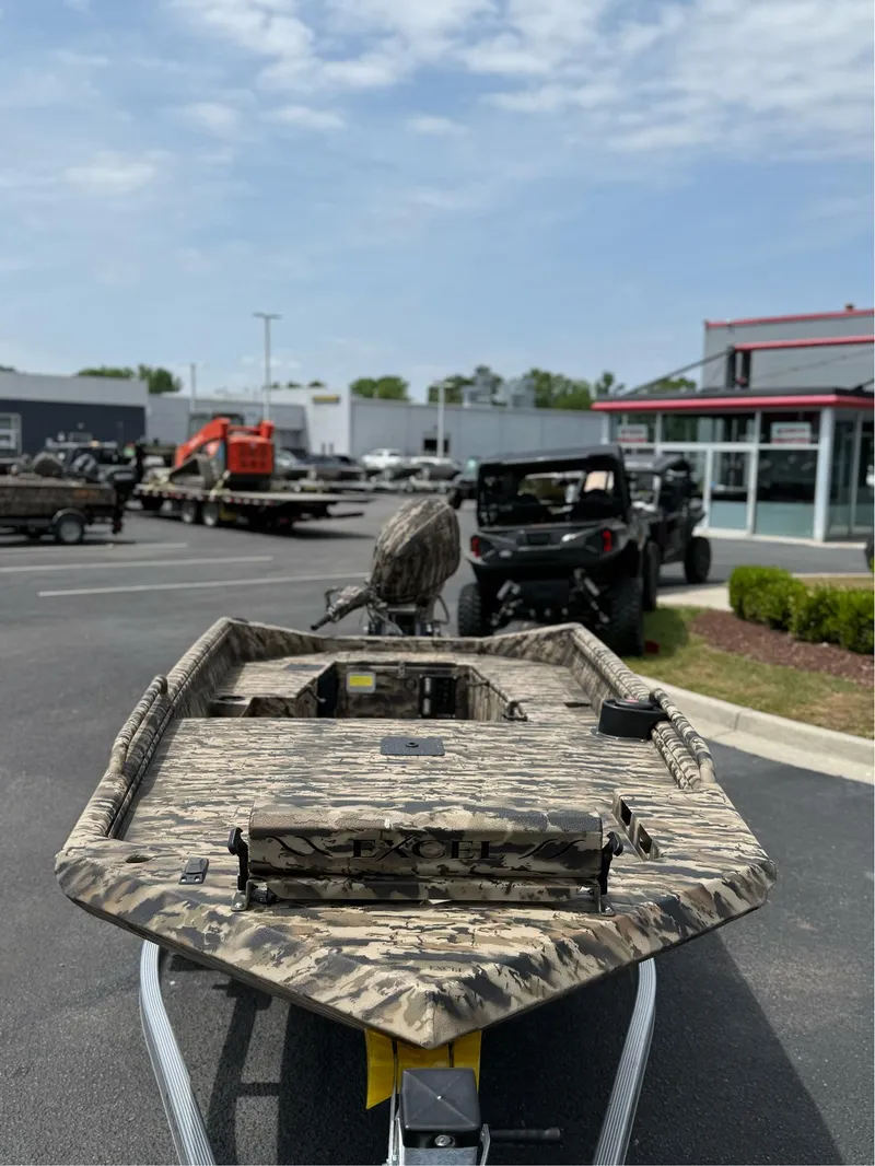 Slide: The Image of 2025 Excel 1651 Viper F4 boat with camouflage design in a dealership parking lot. - 12