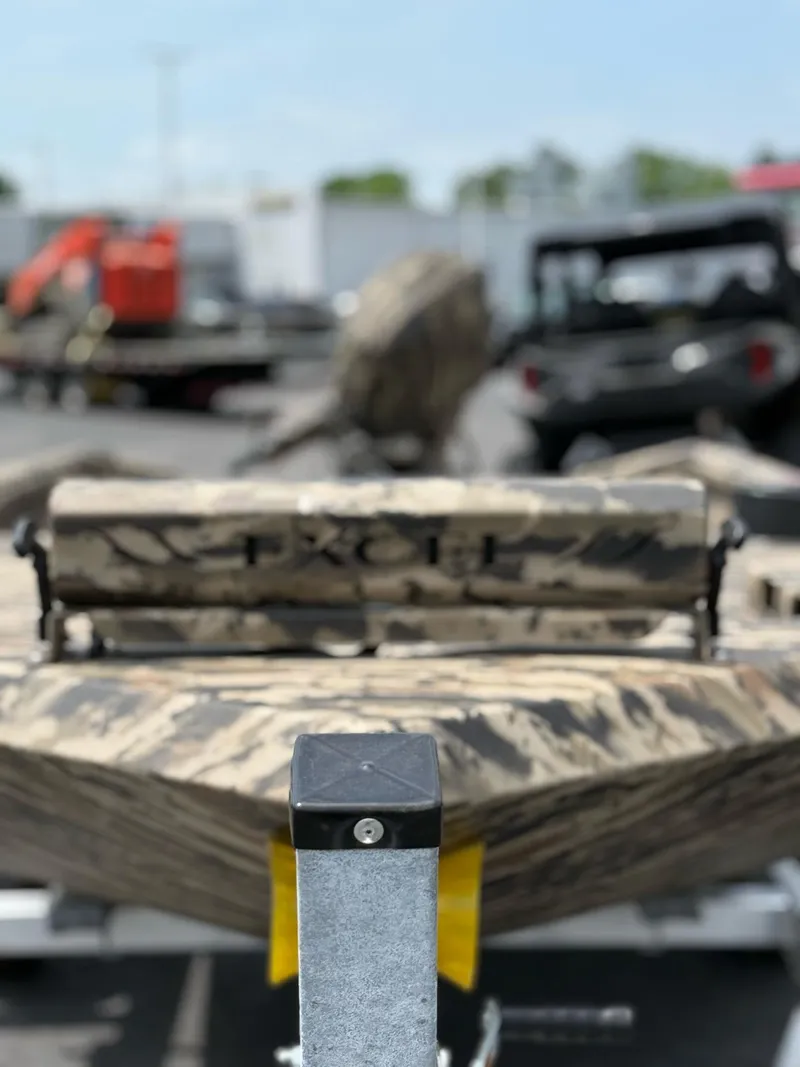 Slide: The Image of 2025 Excel 1651 Viper F4 boat with camouflage design on a trailer. - 13