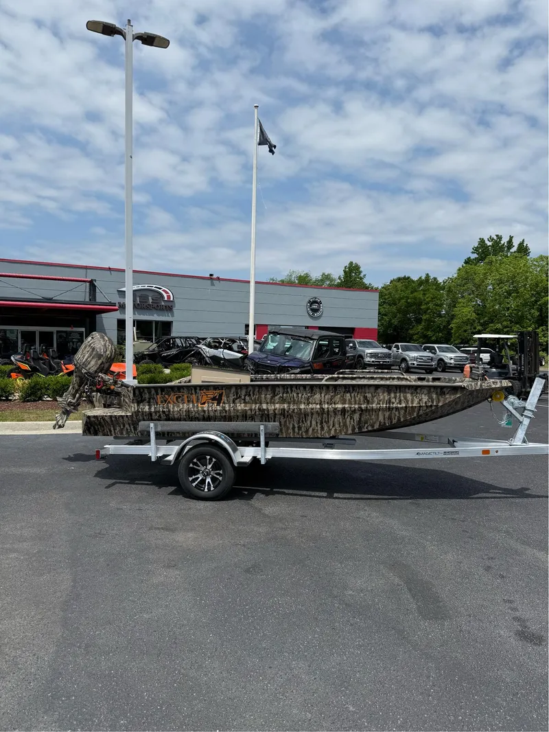 Slide: The Image of 2025 Excel 1651 Viper F4 boat on trailer, parked outside dealership under cloudy sky. - 6