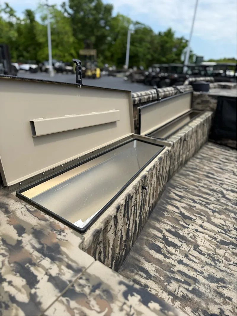 Slide: The Image of Open storage compartments on 2025 Excel 1651 Viper F4 boat, featuring camouflage design. - 8
